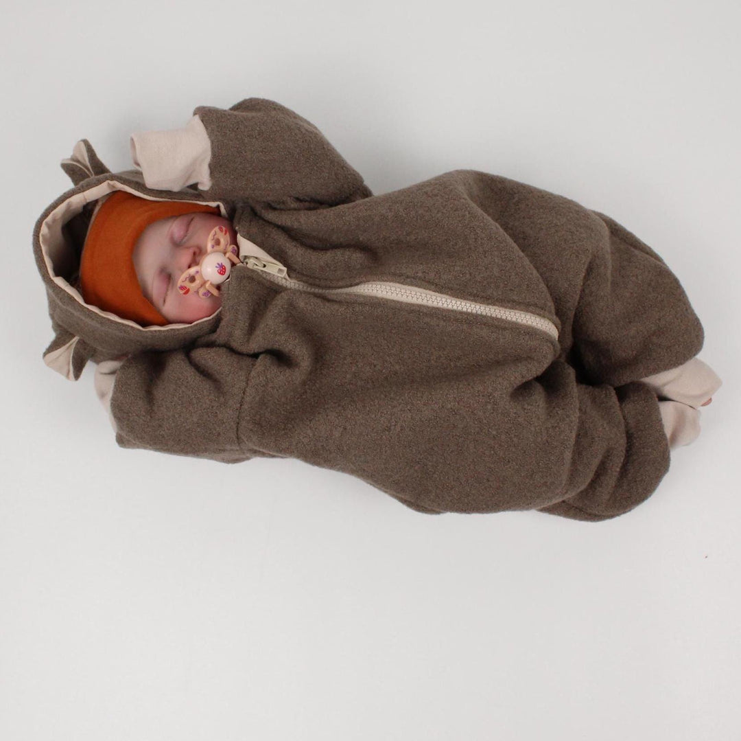 Baby wearing the taupe embroidered Italian wool overall with hood and zip - AnnaKarinna